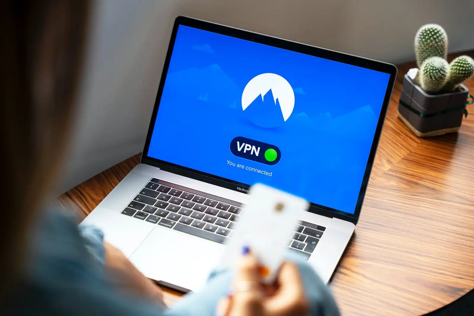 nordvpn 1 macbook pro on brown wooden table